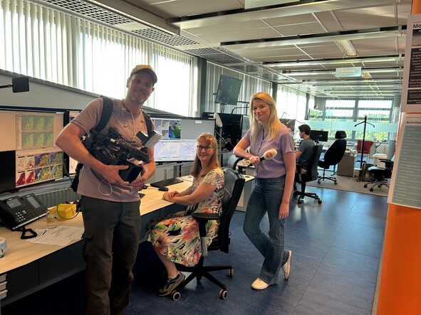 Foto in de weerkamer van het KNMI met verslaggevers en meteoroloog