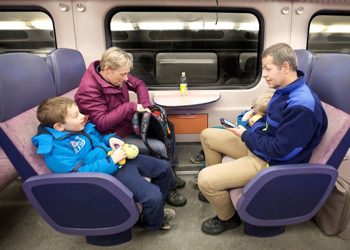 Familie in de trein, Jonathan slaapt, Raphael kletst, Sander kijkt op zjin telefoon